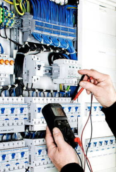 Engineer performing electrical repair and maintenance on industrial machinery Engineer performing electrical repair and maintenance on industrial machinery.