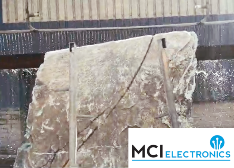 A stone being cut by a stone cutting machine repaired by MCI Electronics.